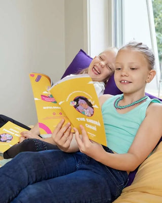 Two young girls enjoying a reading activity from the WipalaBox Emberá Chamí Adventure